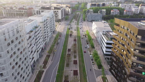 aerial tilt over a tramway and roundabout with traffic montpellier sunset