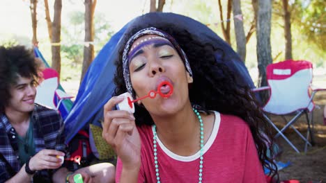 group of friends blowing bubbles at music festival 4k