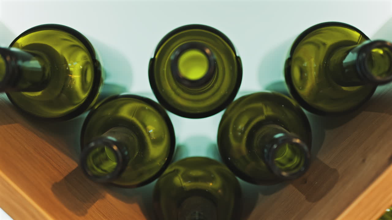 Close up of empty, green, wine bottles on a shelf