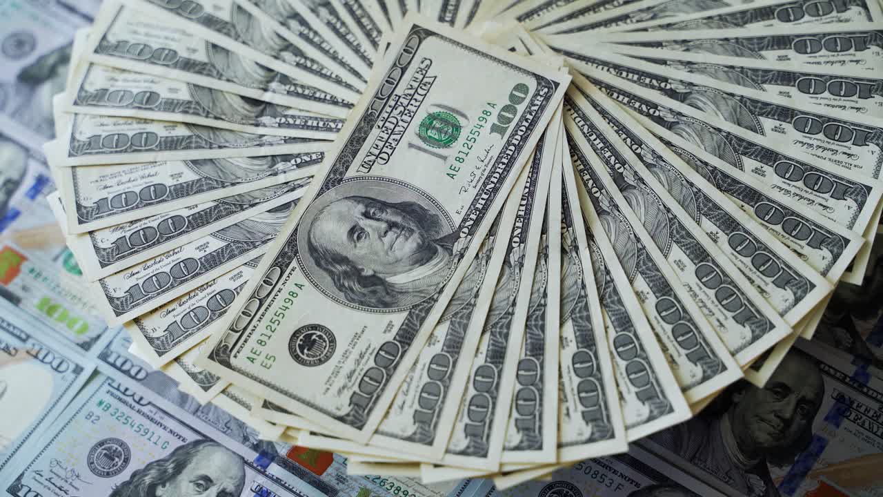 Rotation of paper money. American one hundred dollar banknotes spin. Cash turning around. Beautiful rich background with 100 dollar bills. Close-up.