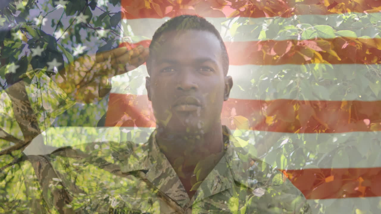 Animación de bandera estadounidense sobre soldado afroamericano saludando y árboles de fondo.