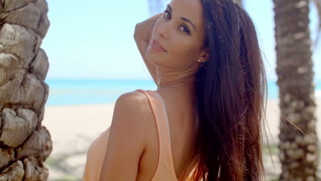 woman with long dark hair looking over shoulder