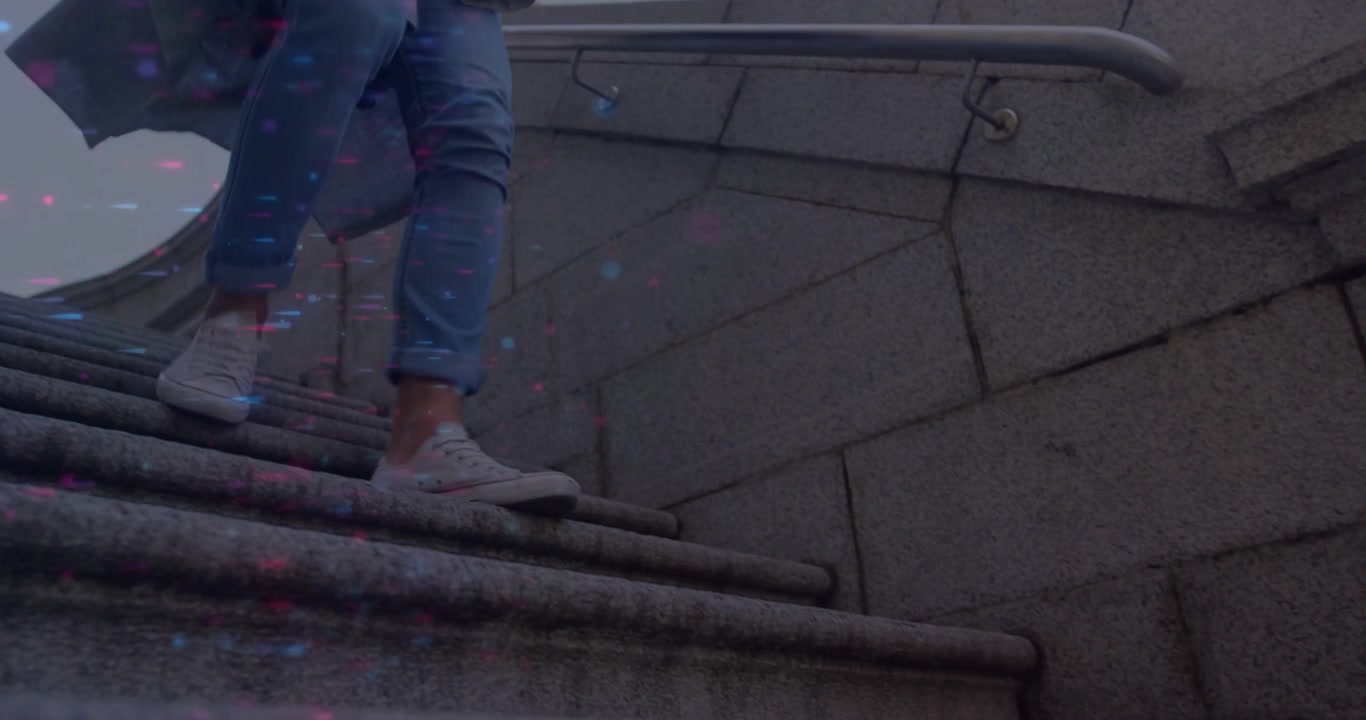 Man descending stone steps while checking phone causing tech overlays marking sneakers passing lens