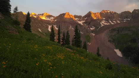 last light mount sniffels 14er peaks wilderness yellow wildflowers upper blue lake colorado summer snow melting top of rocky mountain stunning golden hour sunset silverton telluride 14er cinematic pan