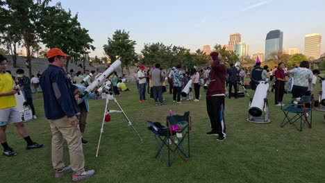 outdoor event with telescopes and city skyline