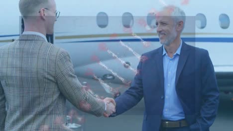 animation of dna structure spinning over two caucasian businessmen shaking hands at an airport