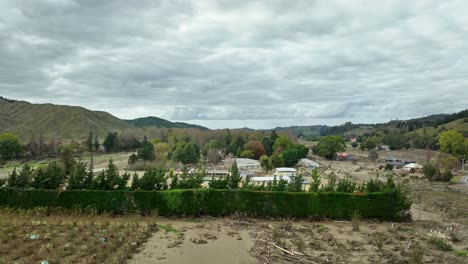 Flooded-valley-in-aftermath-from-cyclone,-torn-farm-land-in-New-Zealand,-aerial