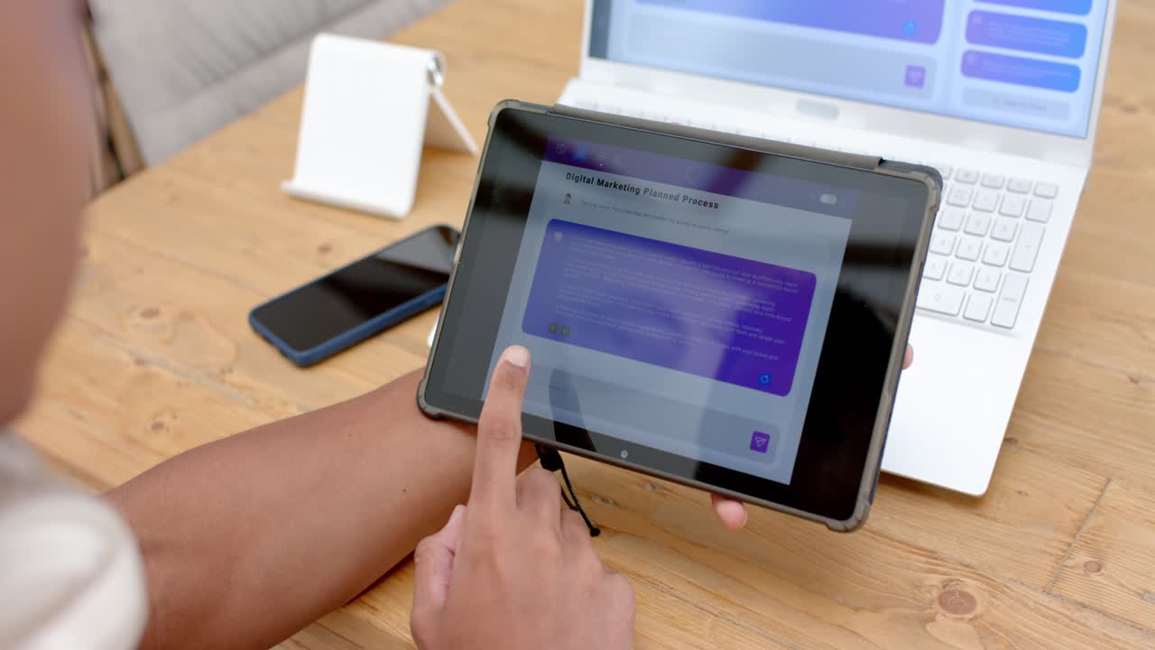 Left hand is placing tablet on tripod on desk; finger is swiping to reveal app content