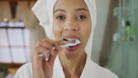 Portrait-of-mixed-race-woman-brushing-teeth
