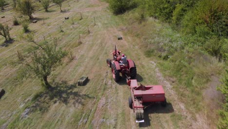 farmer with tractor make bale of hay-3