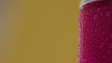 close up shot of person picking up and drinking can of cold beer or soft drink with condensation droplets