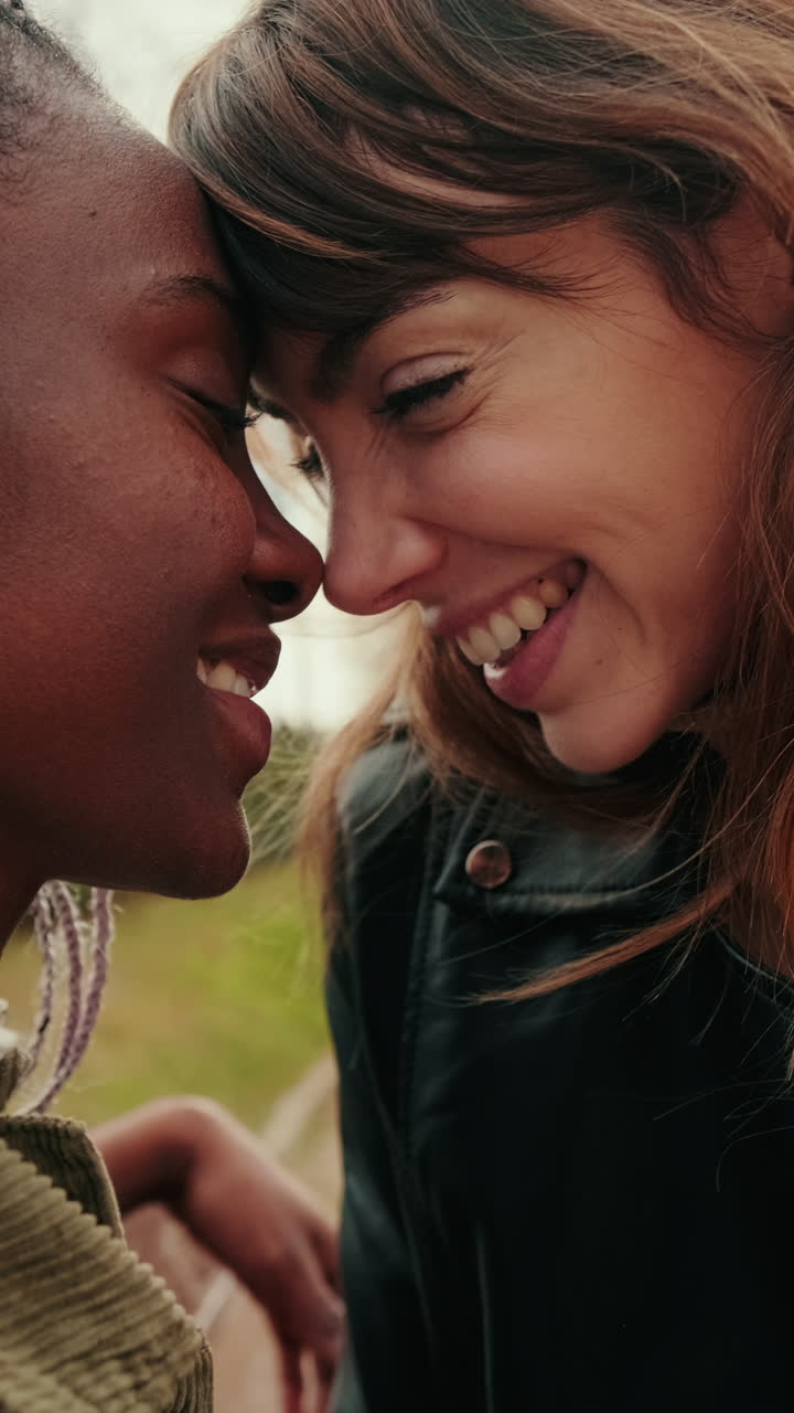 Happy Diverse Lesbian Couple Sharing an Intimate Moment Outdoors