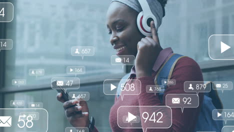 animation of social media notifications over happy african american woman using smartphone