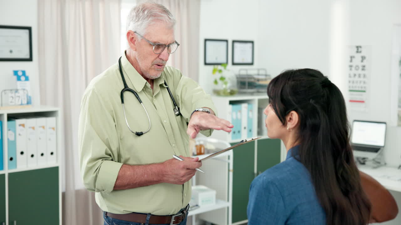 Senior Doctor Consults with Female Patient in Medical Office