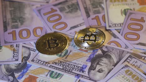 primer plano de metales brillantes monedas de criptomoneda bitcoin en los billetes de un dólar.