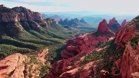 cinematic aerial establishing shot of sprawling sedona arizona valley, merry go round rock