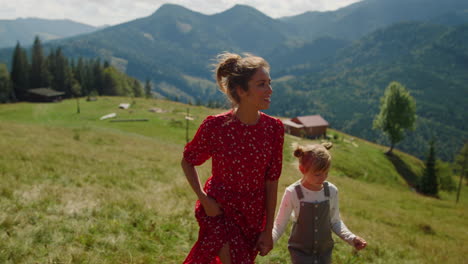 family rest mother daughter coming up mountain slope. woman walking with child.