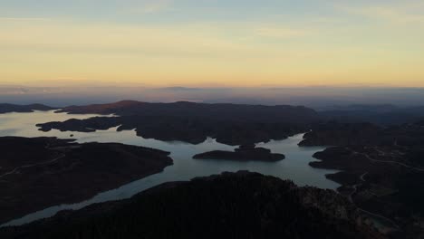 panoramic aerial establishing overview of lake kerkini greece at sunset with glowing soft lit sky