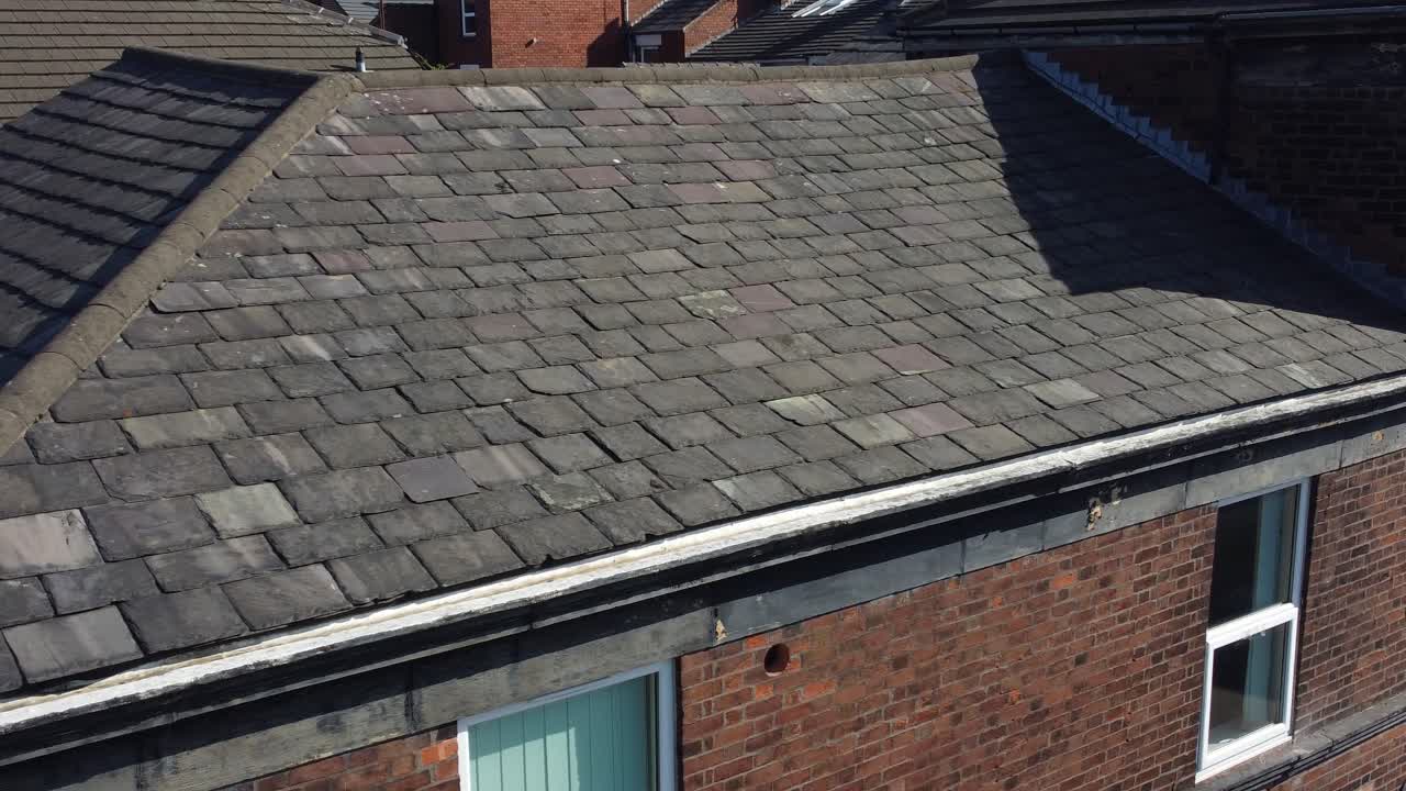 Rooftop inspection aerial view inspecting damage and repair of real estate structure for homeowner