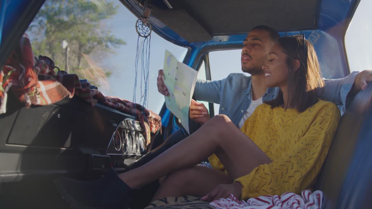 Young couple on a road trip in their pick-up truck