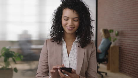 portrait-of-beautiful-stylish-hispanic-business-woman-executive-texting-browsing-using-smartphone-networking-enjoying-mobile-technology-in-modern-office-workspace
