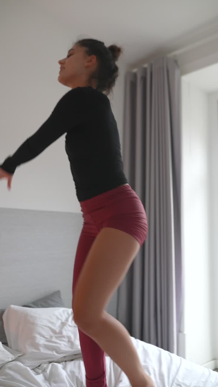 Woman dancing in a bedroom