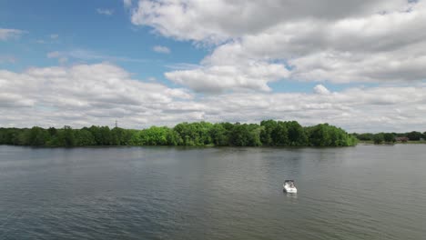 Panaroma-shot-of-a-boat-standing-still-in-a-lake-with-green-trees-on-the-lake-side,-360-view