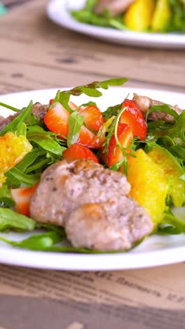 food photography of a salad with meat and fruit