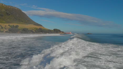 AERIAL:-Surfers-at-Mount-Maunganui-Beach,-New-Zealand