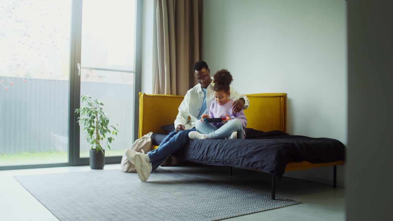 Father and Daughter Playing Video Games Together