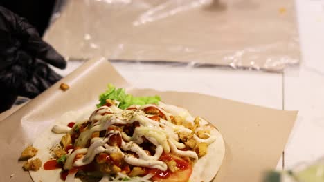 preparing a shawarma wrap