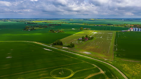 clouds drift overhead, casting shifting shadows across vast agricultural fields in time-lapse.