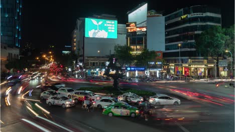 nighttime city street scene with traffic trails in a roundabout