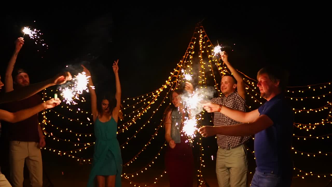 Friends Celebrating at Night with Sparkles