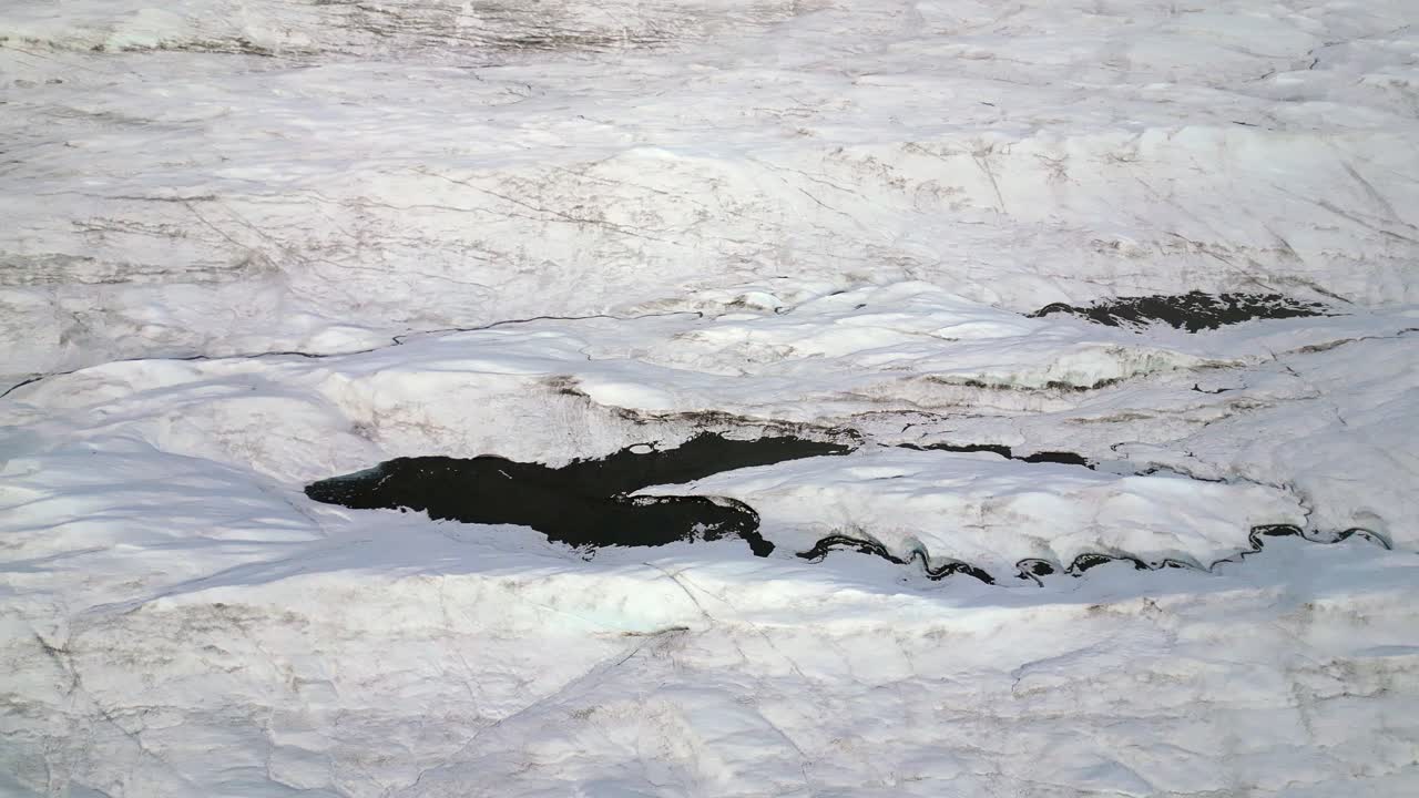 Flowing water carves channels in ice of arctic glacier in Greenland