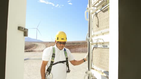 Male-engineer-opening-the-door-of-wind-mill-4k