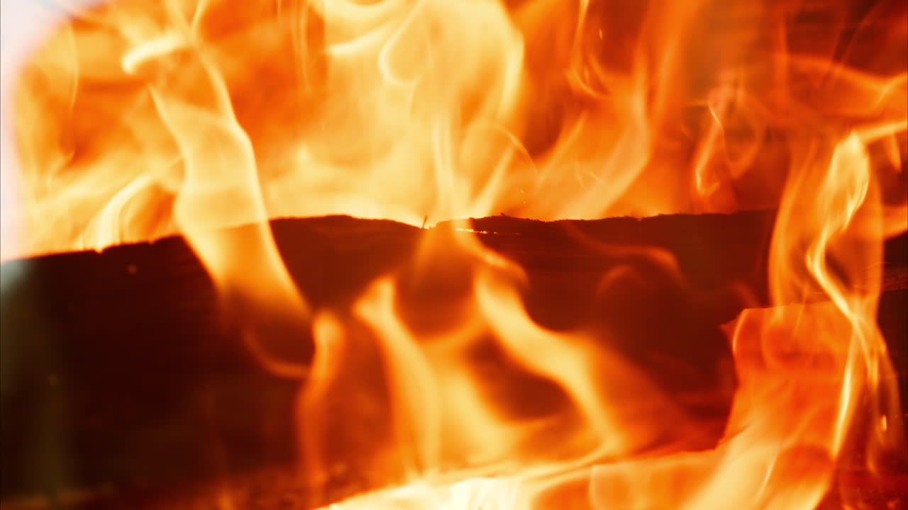 Close up of wood burning with a strong flame in a fireplace