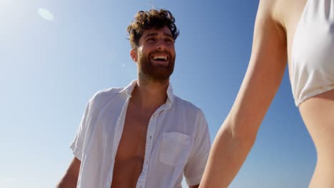 pareja divirtiéndose en la playa en un día soleado 4k