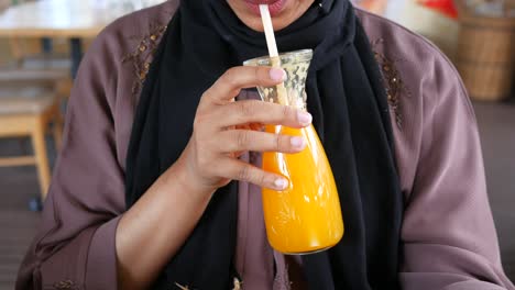 woman drinking orange juice