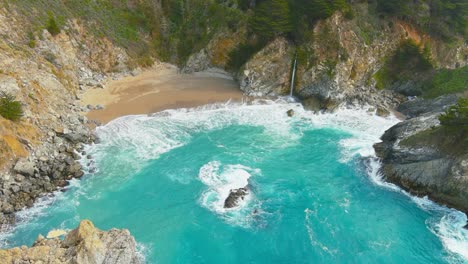 mcway falls on the california coastline | big sur | aerial flyby shot