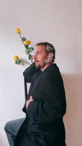 man in black jacket with flowers