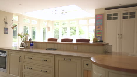 moving shot exiting a rural home and from a large open plan kitchen