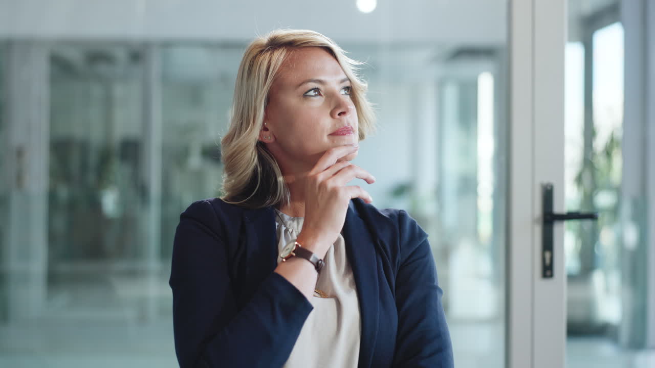 Thoughtful Businesswoman Looking Away and Thinking in Office