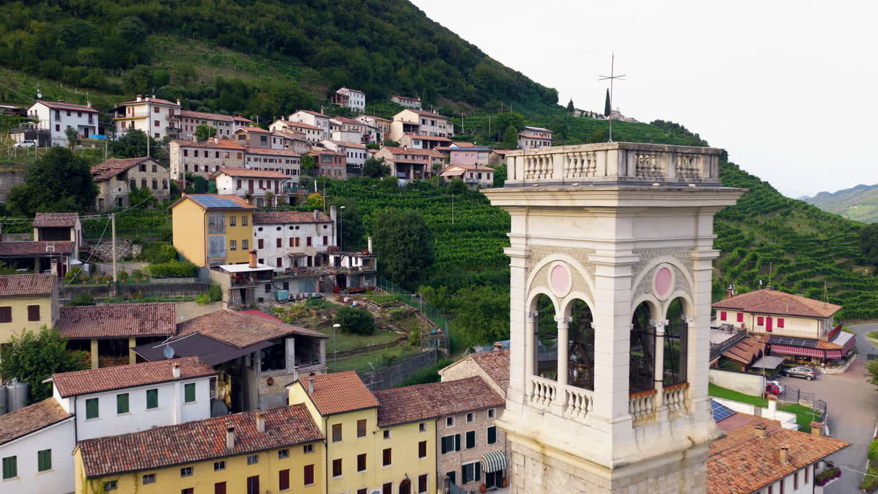 Bell Tower In The Village Of Santo Stefano Within The Valdobbiadene In The Veneto Region Of Italy. Aerial Pullback Shot