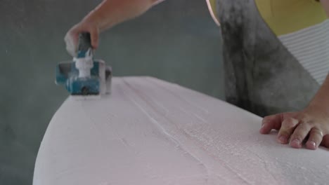 male surfboard maker in his workshop