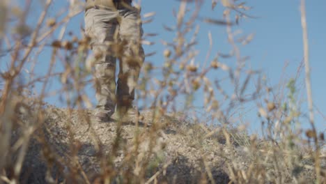 Female-military-soldier-with-a-submachine-gun-running-on-the-battlefield