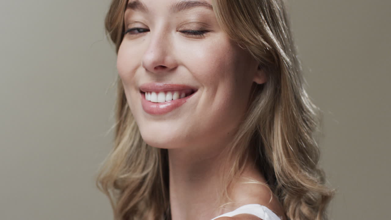 Portrait of smiling caucasian woman with blond hair, copy space, slow motion