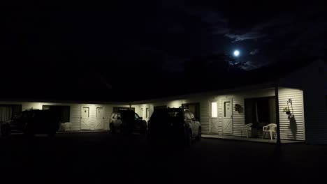 establishing shot of a roadside motel under a full moon at night 1