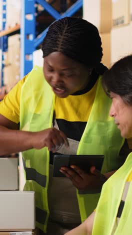 vertical video depot coworkers processing orders and preparing the packages together