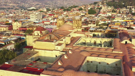 oaxaca historic downtown, aerial view of santo domingo de guzman catholic church and neighborhood, unesco world heritage site on golden hour sunlight, revealing drone shot